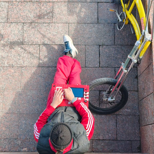 Street musician uses red sampler in Hrodna tracksuit