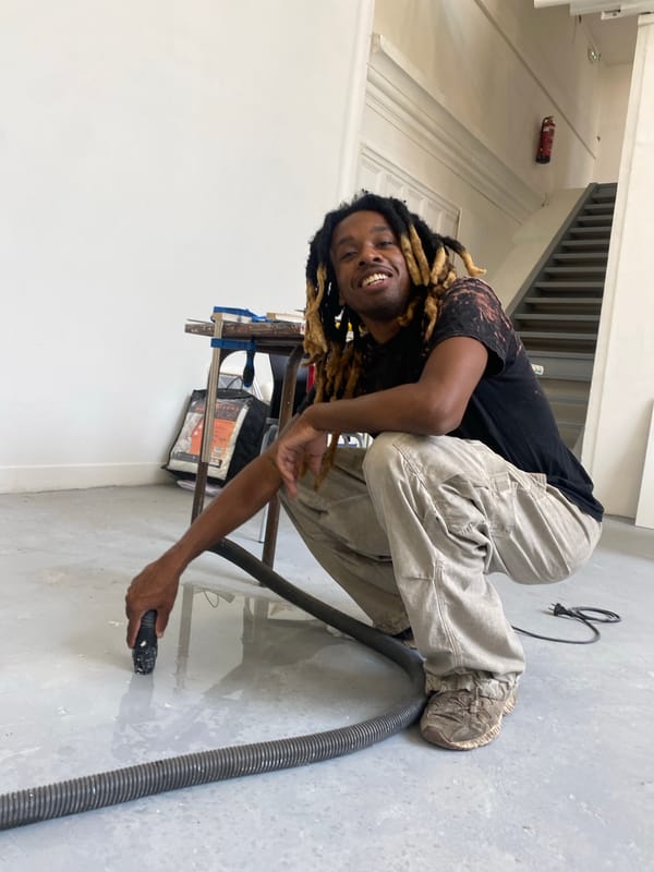 Vacuuming a concrete floor in a Paris studio