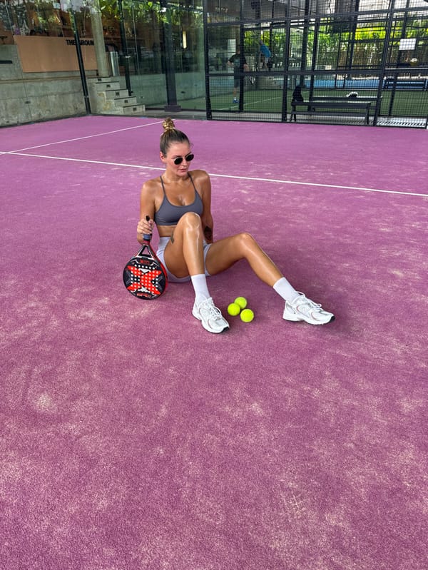 Woman plays paddle tennis on purple court in Bali
