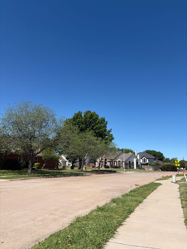 Pedestrian walks residential street in Trophy Club, Texas