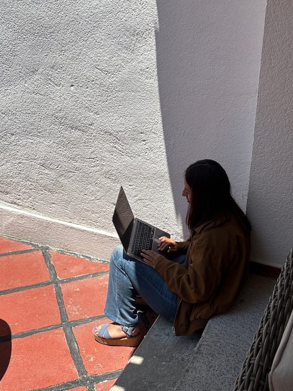 Person documented working with laptop, documents at Puebla co-working space