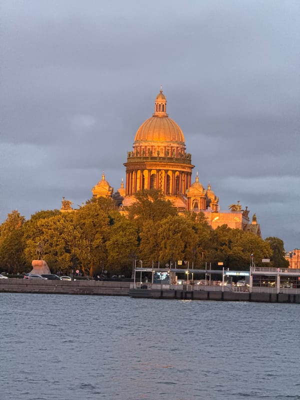 Saint Isaac's Cathedral glows at sunset over the Neva