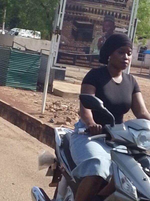 Woman rides scooter through Tamale streets