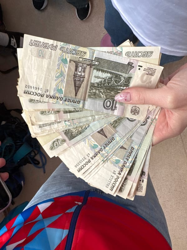 Person displays Russian banknotes in multiple photos in Usolye