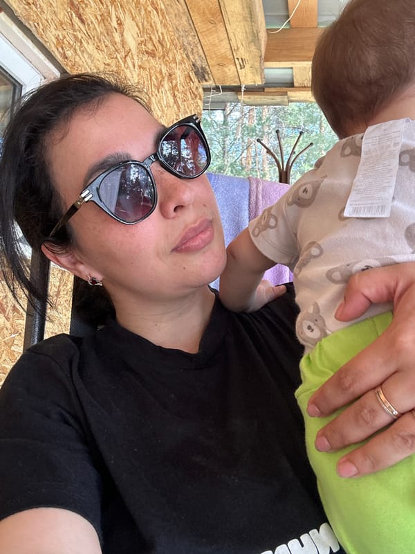Woman and infant share playful moments in outdoor setting