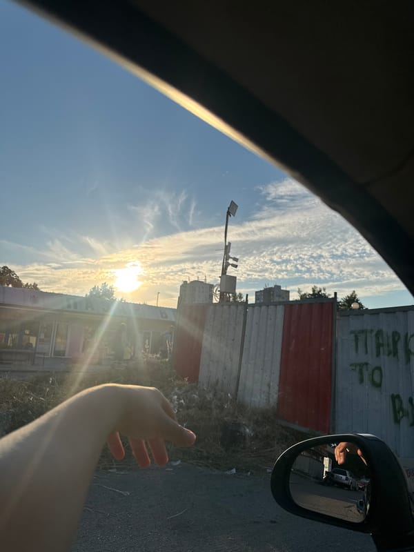 Driving through Burgas at golden hour past industrial streets