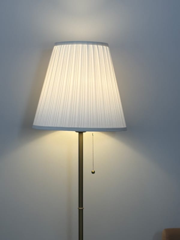 Wall lamp with white pleated shade documented in Moscow