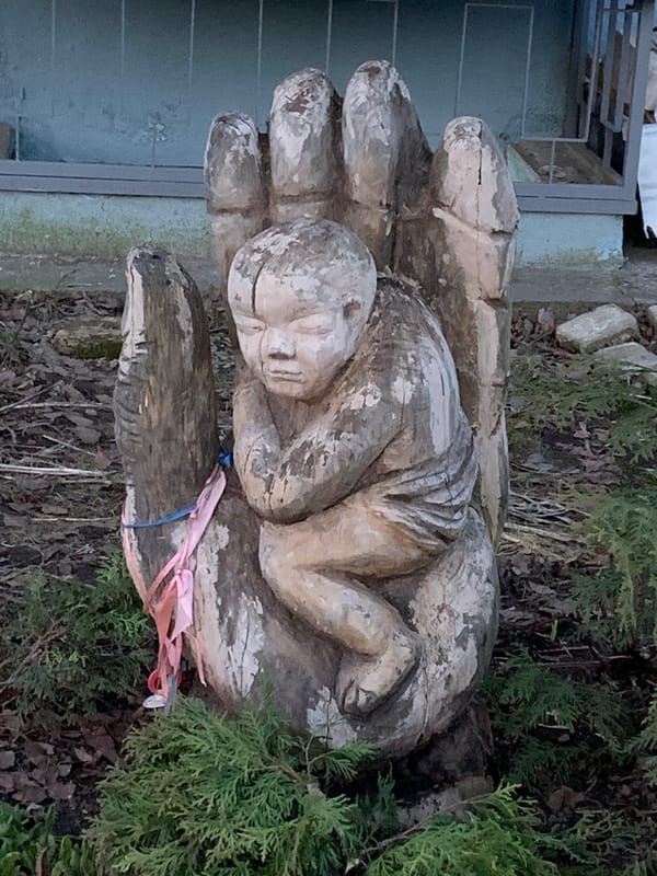 Woman photographed at wooden sculpture in Chaikovsky, Russia