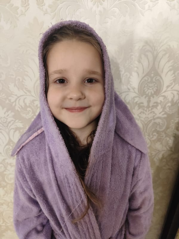 Child and cat captured in everyday home moments, Krasnodar
