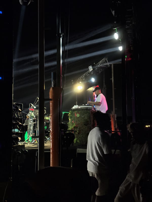 Outdoor DJ set at a beachside venue in Aksu at night