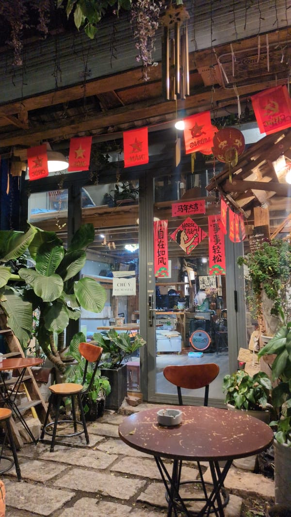 Business storefront with red signage photographed in Da Lat