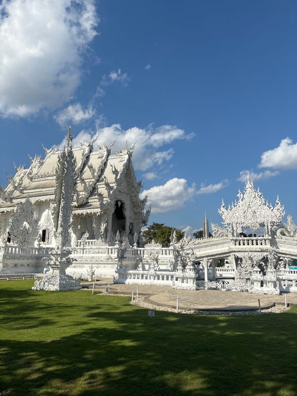 Visitors document Thailand's White Temple complex during morning hours