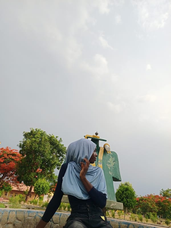 Woman in blue hijab documented in outdoor public space