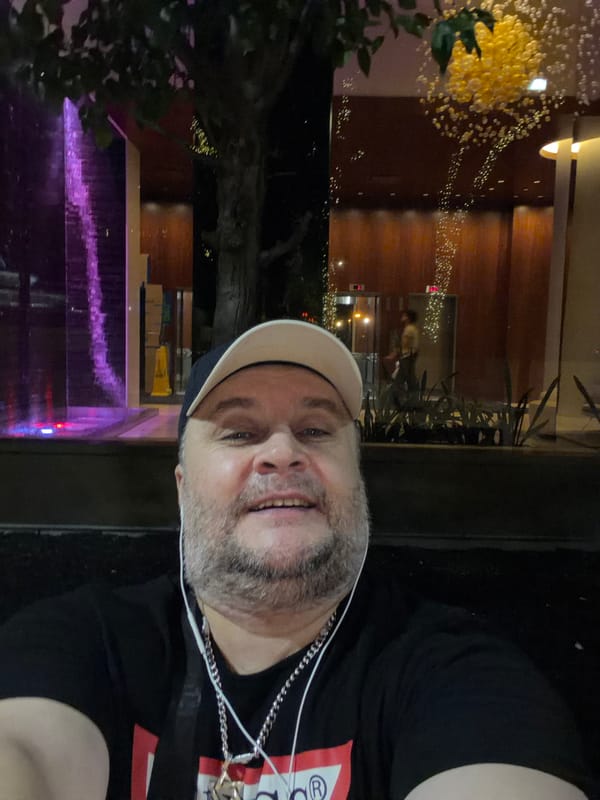 Late-night selfies at a lit fountain plaza in New York
