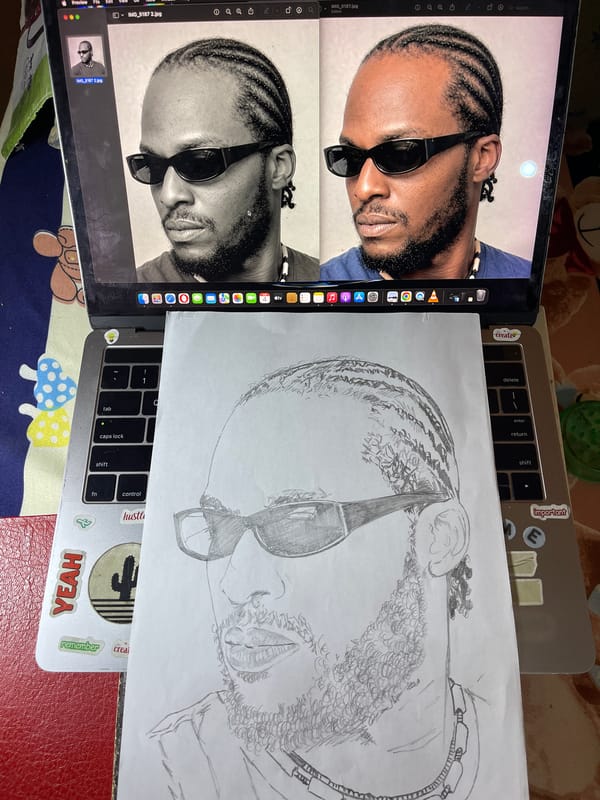Artist sketches detailed portrait from laptop reference in Jos