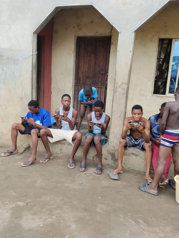 Young men gather on building steps in Aba, Nigeria