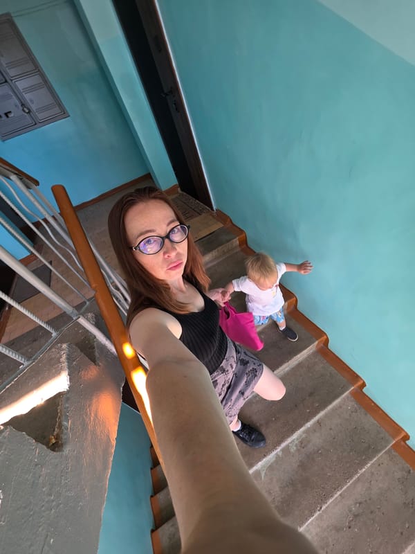 Selfies and staircase moments at a teal-walled outdoor spot