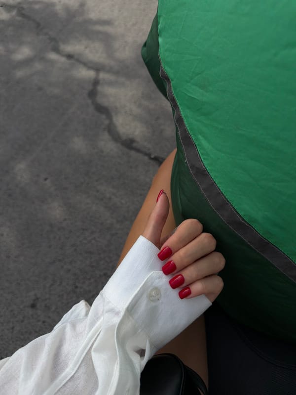 Hand with square fingernails photographed in Kuta, Indonesia