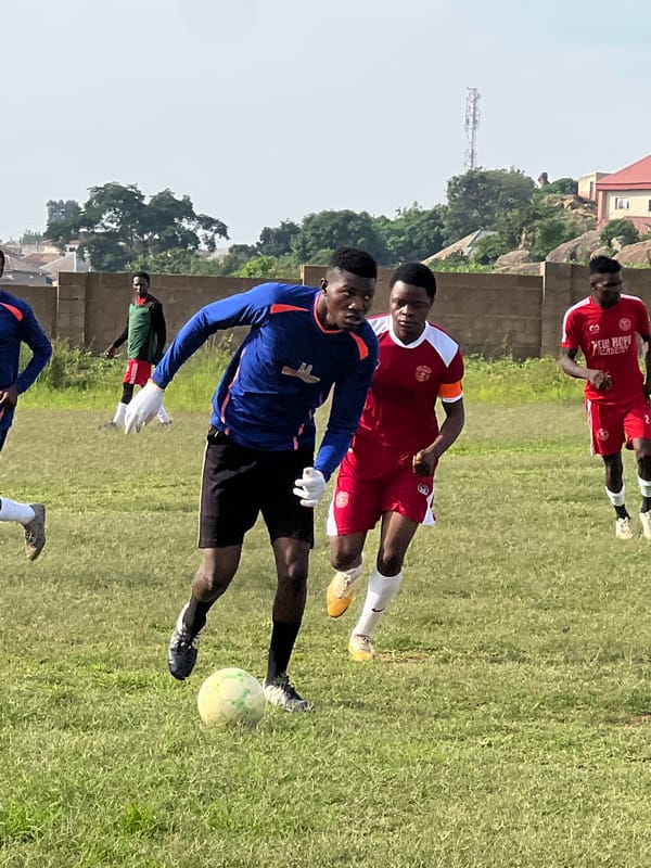 Pickup soccer match on a patchy field in Jos, Nigeria.