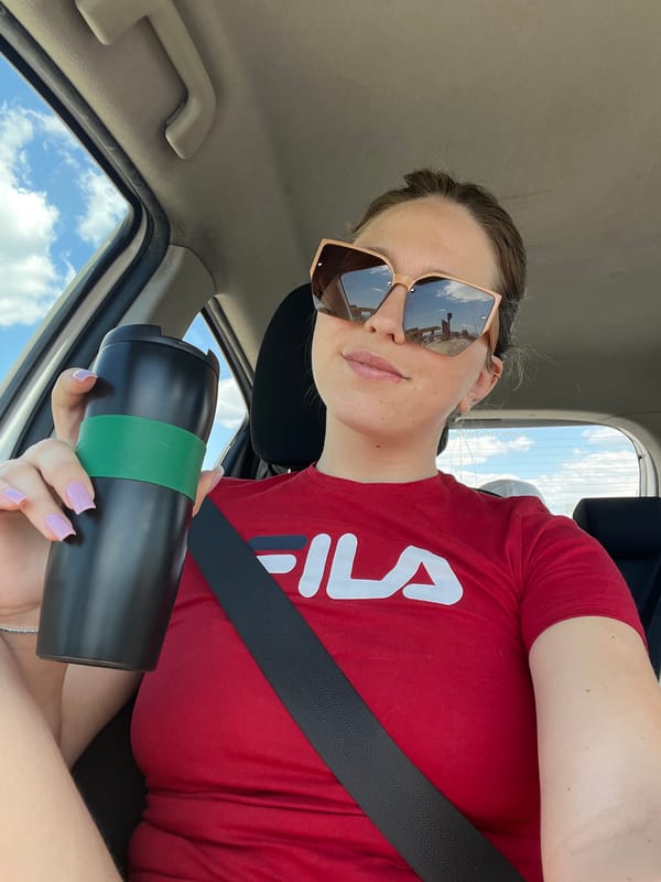 Woman in red Fila shirt observed in car, Montenegro