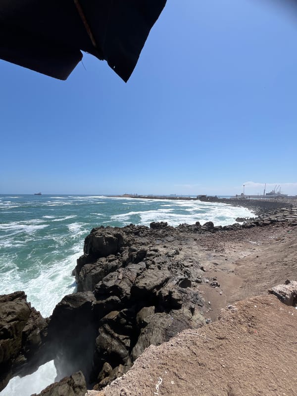 Waves crash against rocky Arica coastline, Chile