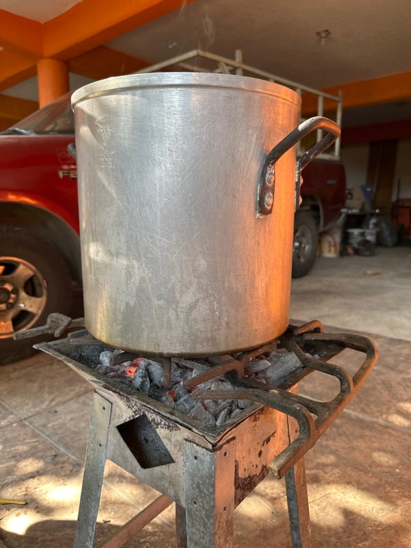 Outdoor cooking scene documented in Acapulco garage area
