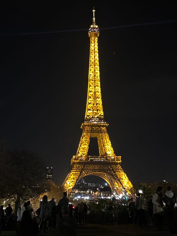 Eiffel Tower draws evening crowds under golden illumination