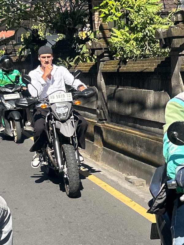 Morning scooter traffic flows through North Kuta, Bali