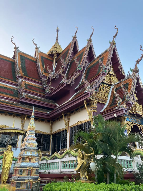 Visitors document ornate Wat Plai Laem temple complex in Thailand