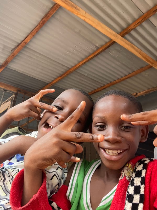 Arsenal fan flashes peace sign in Onitsha street