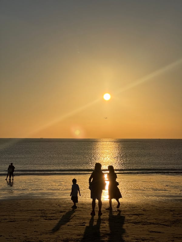 Kuta Selatan beach at golden hour, crowds and kites included