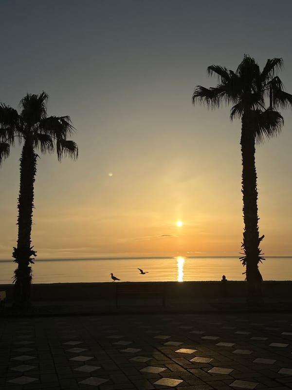 Golden sunrise captured over calm waters in Lipari, Italy