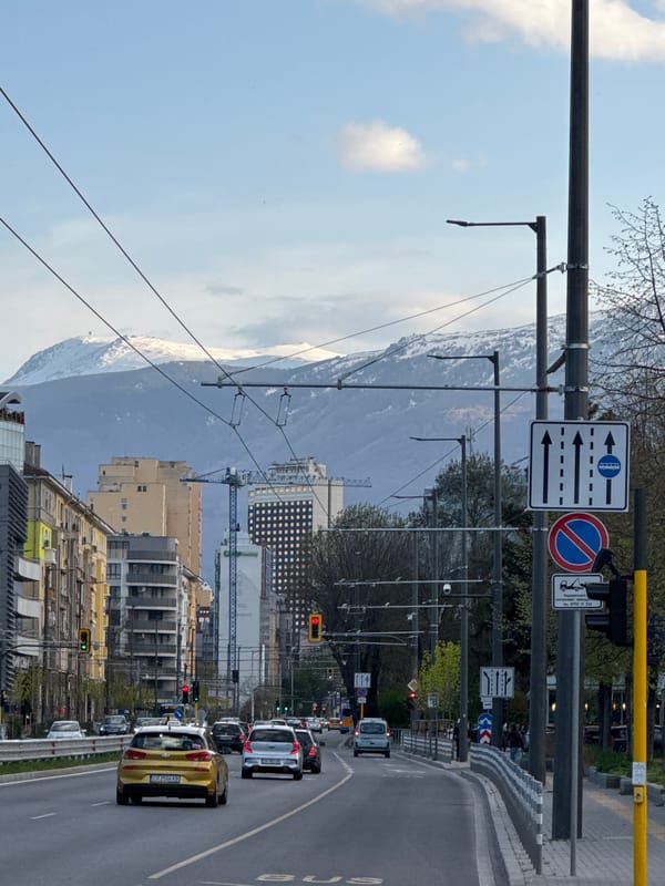 Traffic flows on Sofia street with mountain backdrop