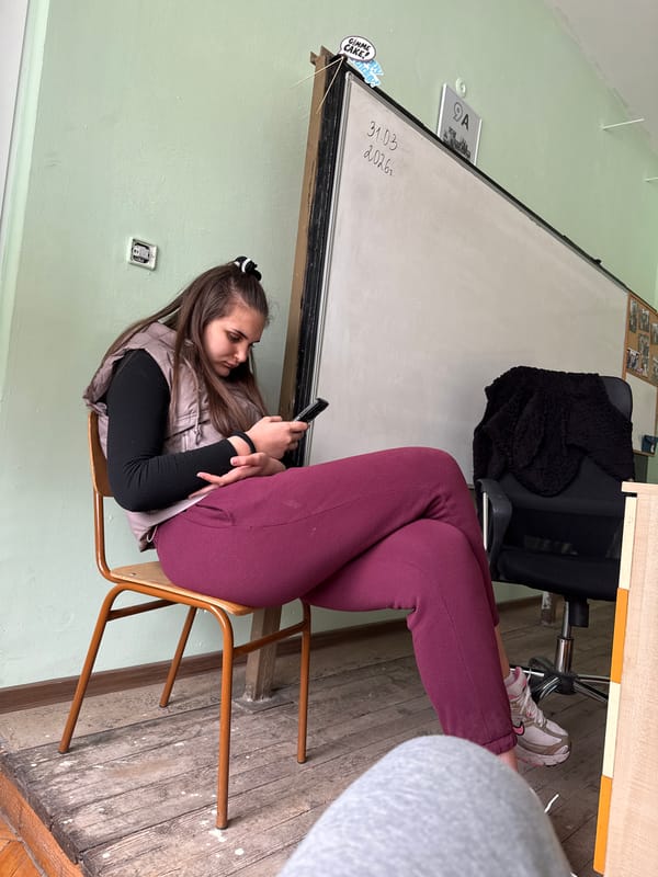 Students use phones during classroom break in Bulgaria