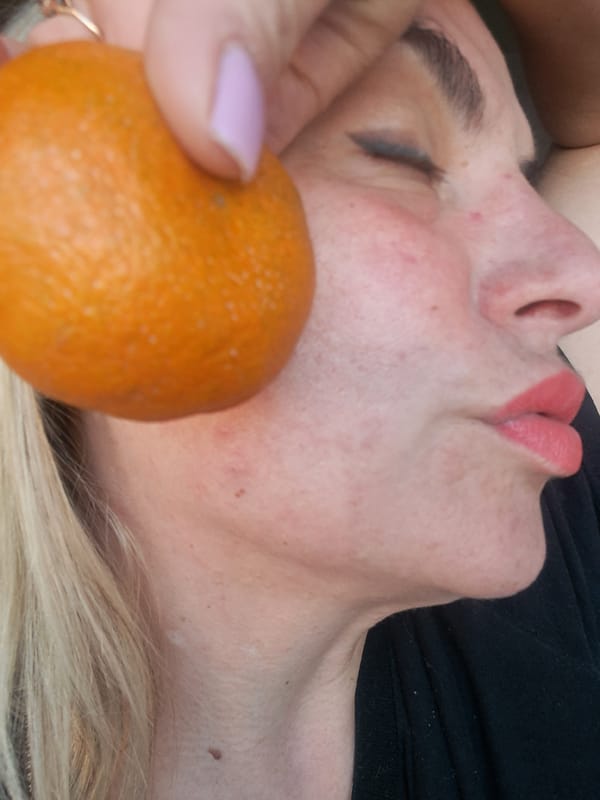Woman photographed with orange in intimate portrait session