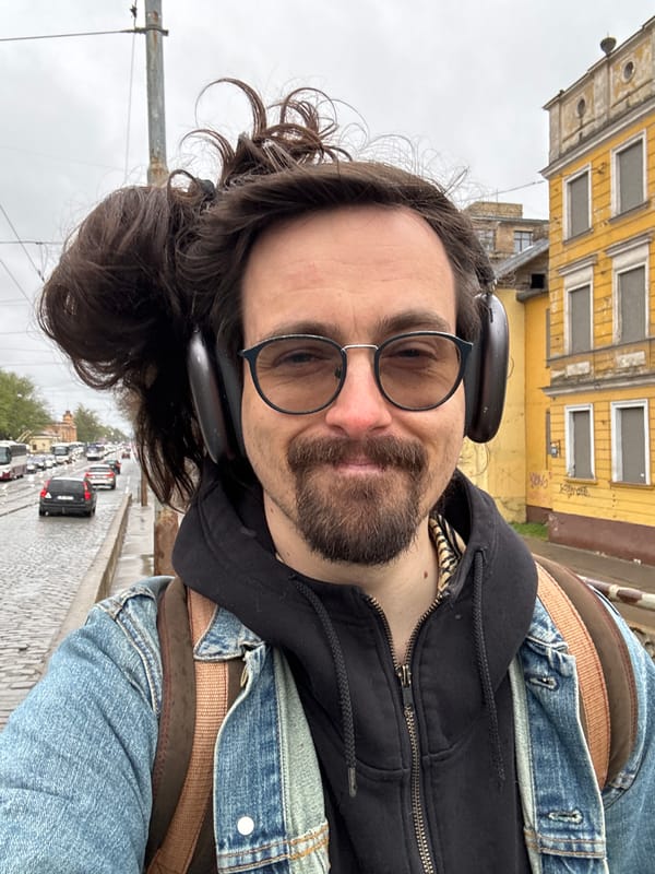 Man takes early morning selfie on wet Riga street