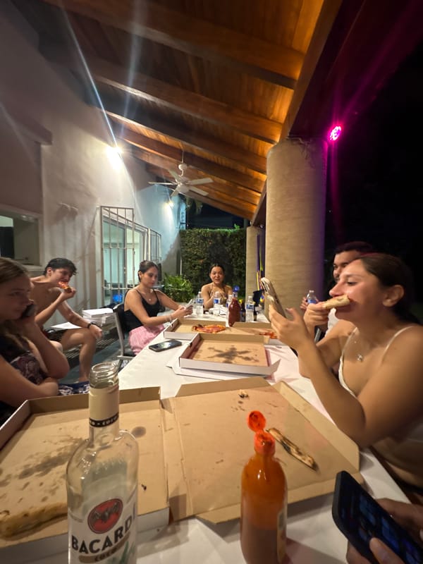 Late night pizza gathering on patio in Puerto Escondido