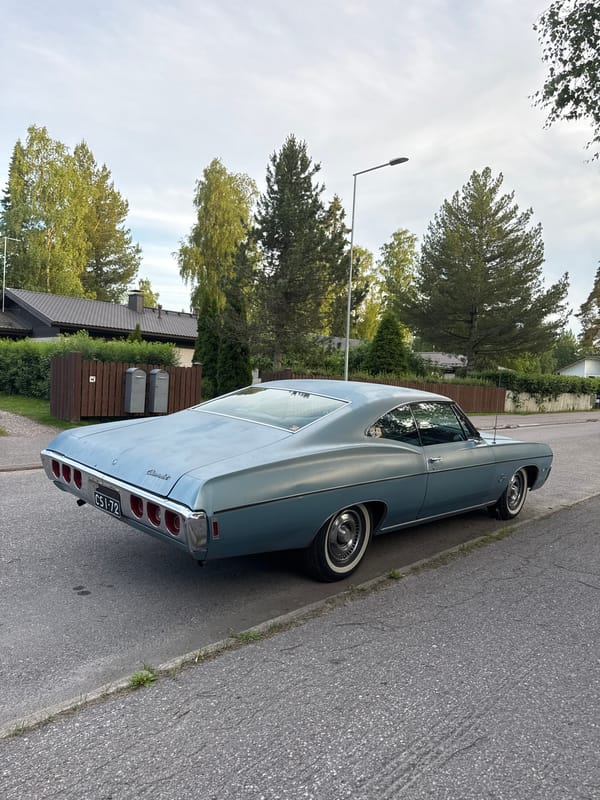 Vintage Impala and street details along a quiet residential path