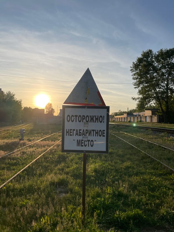 Person documents railway areas during evening walk in Brest