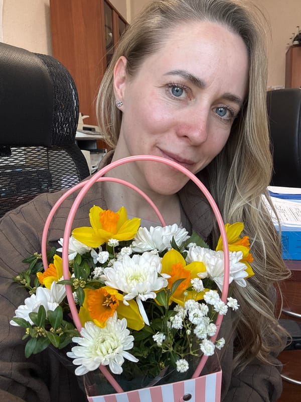 Woman holds spring flower bouquet in Chaikovsky, Russia