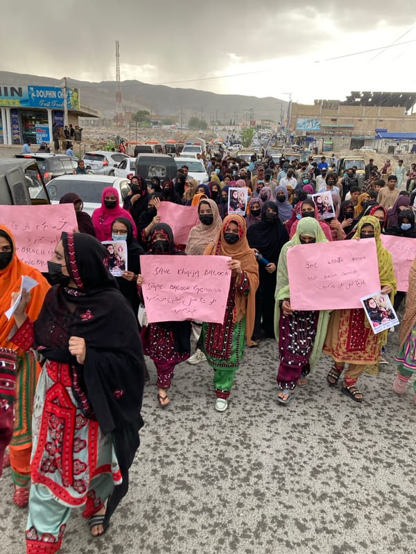Women demonstrate with pink signs in Quetta, Pakistan
