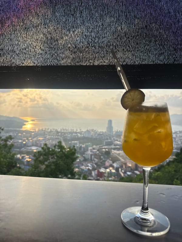 Sunset cocktails captured from elevated Patong restaurant balcony