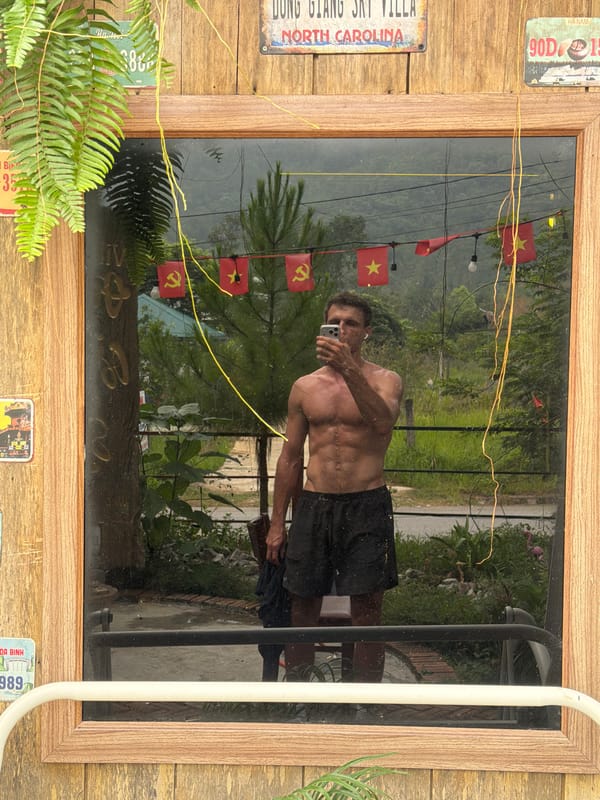 Man takes mirror selfie with Vietnamese flags in Đà Nẵng