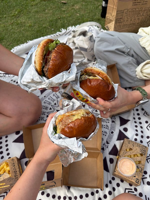Three people enjoy afternoon picnic in Tel Aviv park