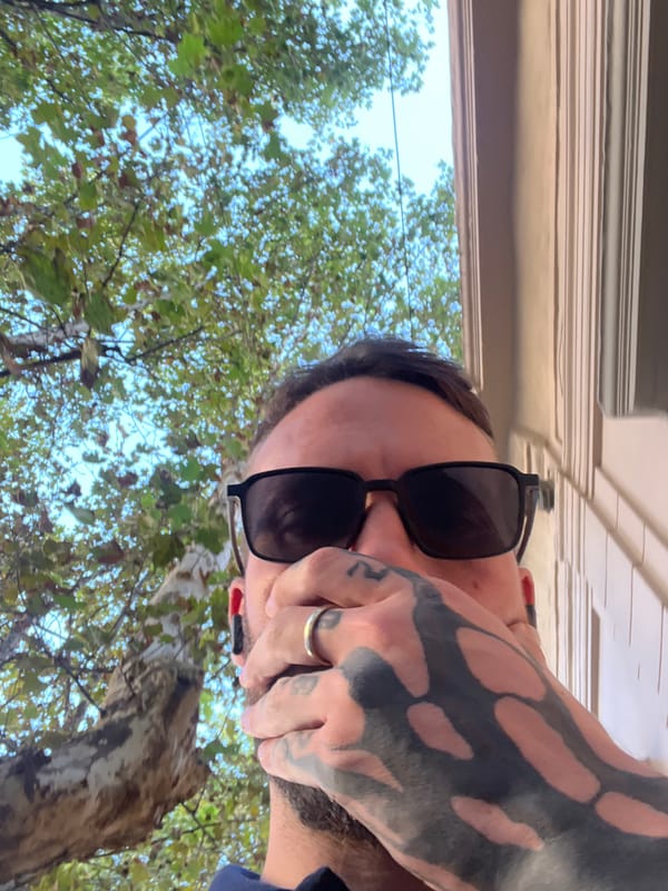 Tattooed man takes selfies in Cordoba elevator and outdoors