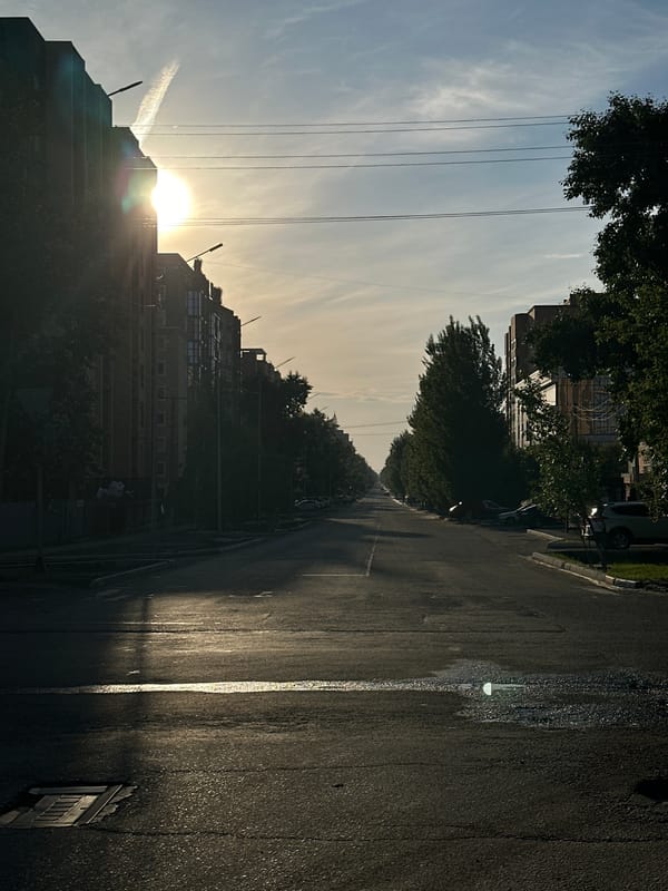 Evening sun observed behind high-rise building in Kokshetau