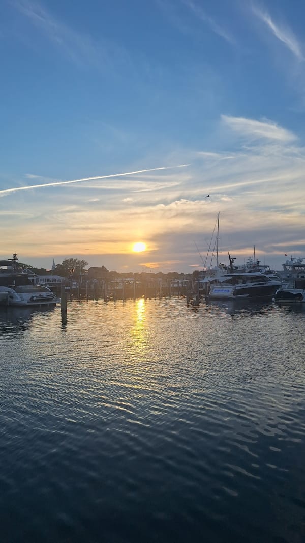 Nantucket harbor fills with yachts under a golden summer sunset
