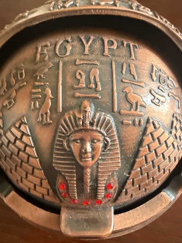 Egyptian décor, seashells, and tea on a wooden surface