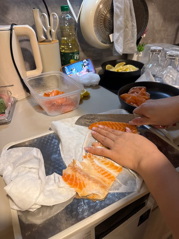 Person prepares salmon dinner in Kathu kitchen Tuesday evening
