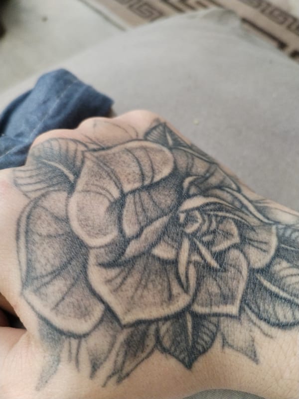 Close-up photos of hand tattoo and carpet captured in Ghent